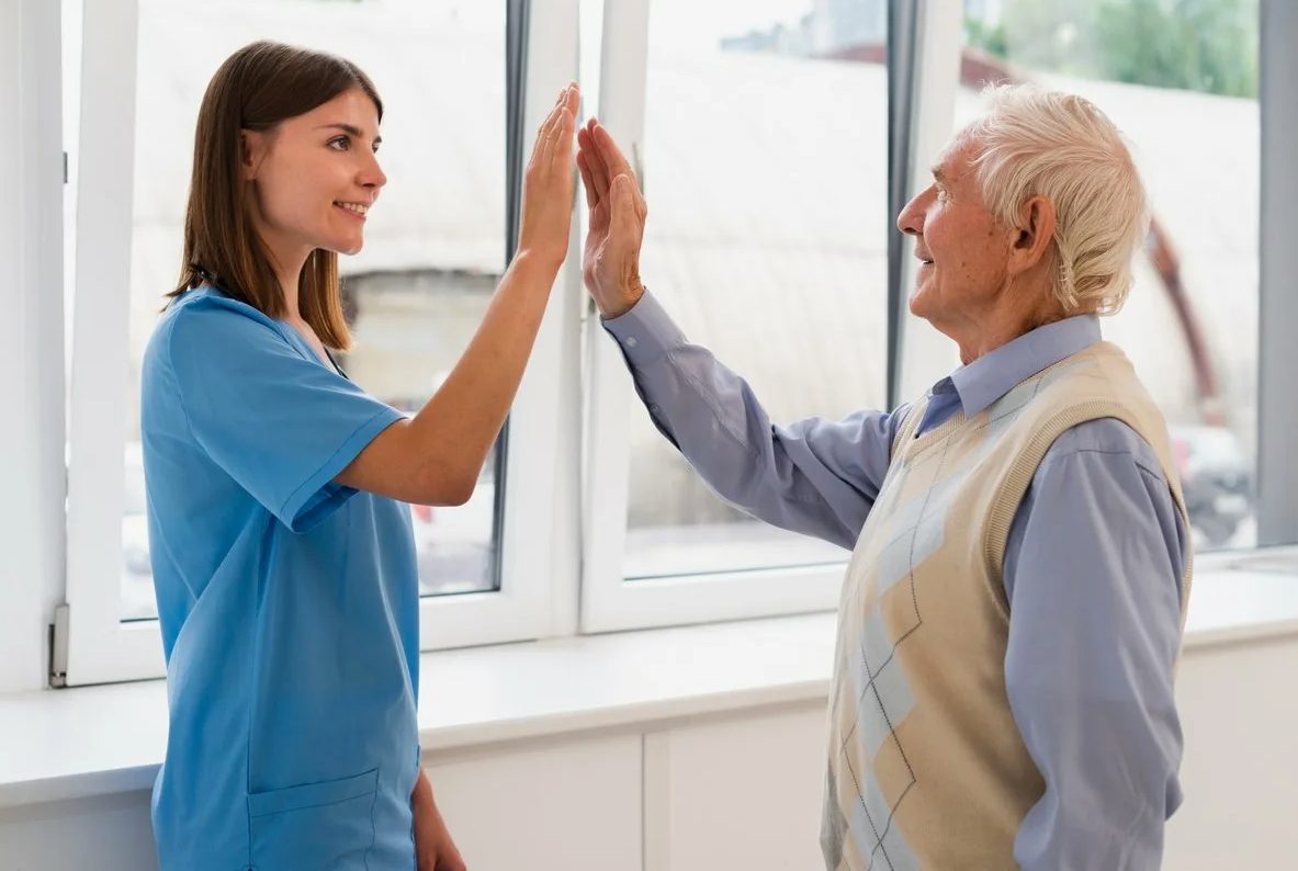 A healthcare professional celebrating progress with a patient